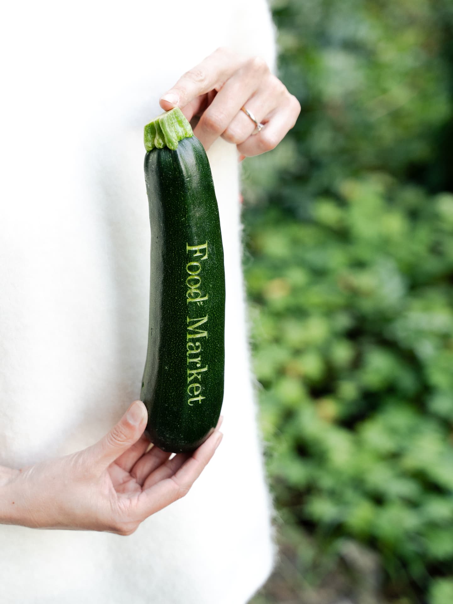 Laser engraved 'Food Market' lettering on a courgette